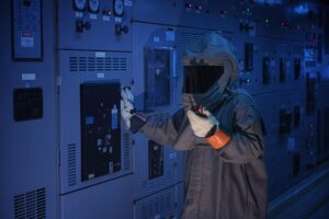Engineer wear a arc flash protection suit for inspection electrical current and checking status switch gear electrical energy distribution substation